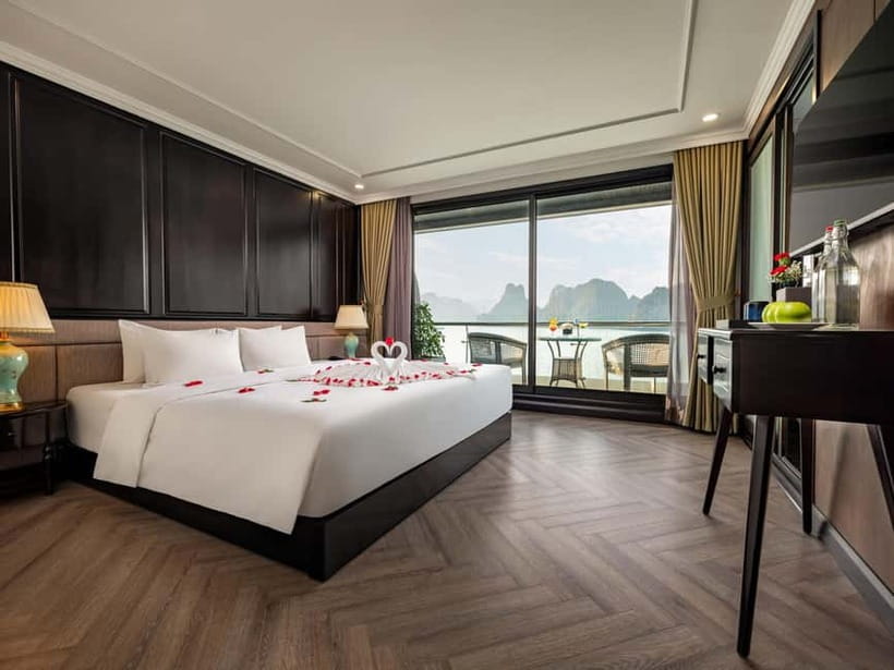 2-Day or 3-Day: Halong&Lan Ha Bay Cruise 5<em> balcony,bathtub – Key points to know before booking’ /></p>
<ul>
<li><strong>The 2-day cruise skips Viet Hai Village</strong>, while the 3-day cruise adds cycling, a village visit, extra swimming, and another night onboard.</li>
<li><strong>Every cabin has a private balcony and bathtub</strong>, along with modern facilities and daily mineral water.</li>
<li><strong>Tra Bau is used for kayaking and swimming</strong>, with a jacuzzi available onboard if you prefer to stay dry.</li>
<li><strong>Dark and Bright Cave is visited by kayak or local bamboo boat</strong>, giving you a choice between paddling yourself and being rowed.</li>
<li><strong>The cruise includes a cooking class, sunset party, squid fishing, and karaoke</strong>, but evening entertainment can be quiet.</li>
<li><strong>Hanoi or Ninh Binh transfers are optional</strong>, and the shared limousine journey can take around three hours each way.</li>
</ul>
<h2>A comfortable ship, with the bay as the main event</h2>
<p><img width="820" height="615" decoding="async" src=
