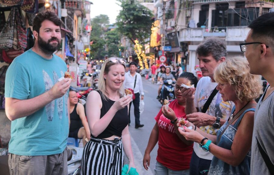 Discover Hanoi's Street Food by Night & Mini Class Coffee - Markets, heritage buildings, and an old city gate