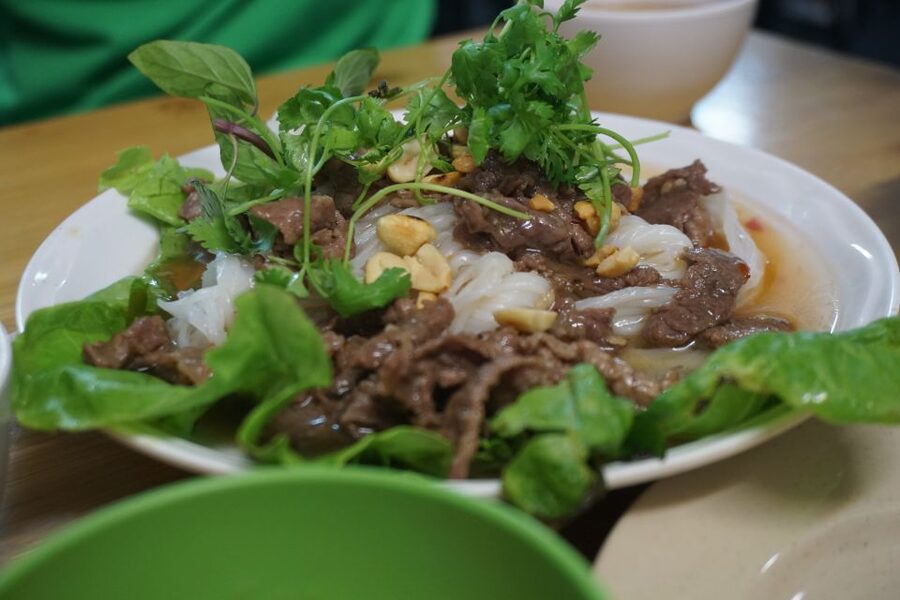 Enjoy Hanoi Like a Local - Vespa & Street Food Tour by Night - Street food in small lanes around Truc Bach Lake
