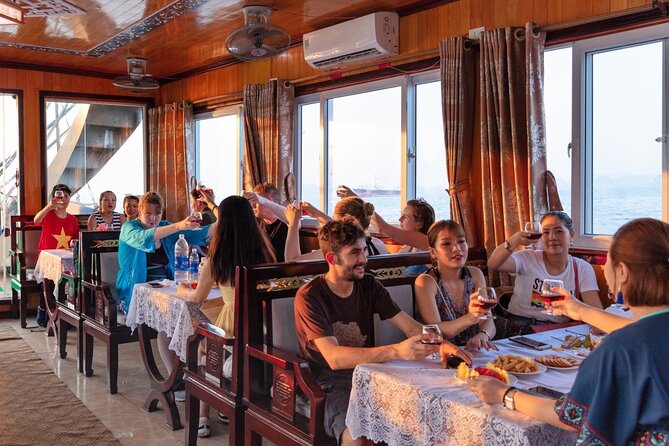 Halong Bay Day Tour With Titop Island, Cave, Kayak & Lunch - Sunset fruit, cake, and the ride back to Tuan Chau