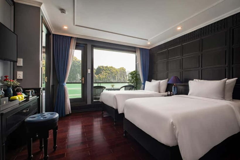 Hanoi: 2-Day Halong-Lan Ha Bay BEST SELLER 5<em> cruise balcony – Key points at a glance’ /></p>
<ul>
<li><strong>Kayak or paddle by bamboo boat:</strong> Visit Dark and Bright Cave, or head toward Ba Trai Dao Beach, depending on the tide.</li>
<li><strong>Sleep beside the bay:</strong> Your Junior Suite includes air conditioning, an ensuite bathroom, and a private balcony.</li>
<li><strong>A busy but varied schedule:</strong> Swimming, kayaking, spring-roll making, squid fishing, tai chi, and cave visits fill the short cruise.</li>
<li><strong>The ship is assigned by availability:</strong> Several newly built 5-star steel-hull cruises operate this route, so the exact vessel is not guaranteed.</li>
<li><strong>Useful Hanoi transport:</strong> Pickup is offered from Hanoi Old Quarter, with limousine transfer to Tuan Chau Port and return to Hanoi.</li>
<li><strong>Special occasions get attention:</strong> Anniversary cabin decorations and a birthday cake are included when conditions are met.</li>
</ul>
<h2>What this Halong and Lan Ha Bay cruise really offers</h2>
<p><img width="820" height="461" decoding="async" src=