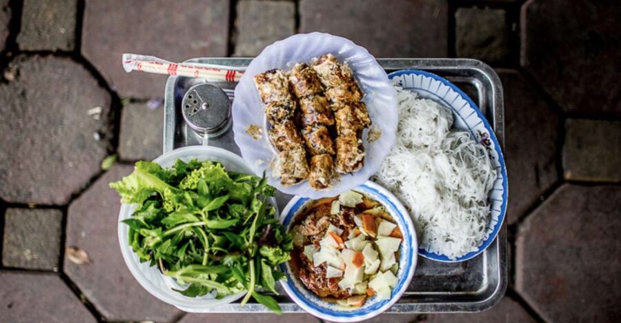 Hanoi: 7 Tastings Street Food Tour with Train Street - Stop two: Hanoi’s grilled pork and noodles