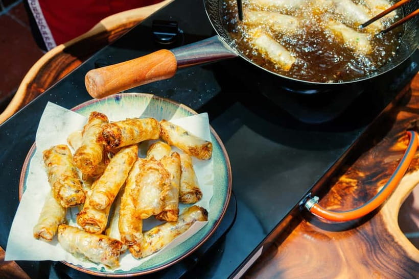 Hanoi Cooking Class: Market Tour, Free Recipe & Beverages - Sitting down to eat with local wine
